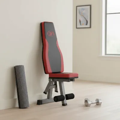 Bowflex 5.1S Stowable Weight Bench folded upright against a wall, demonstrating its space-saving design for small home gyms